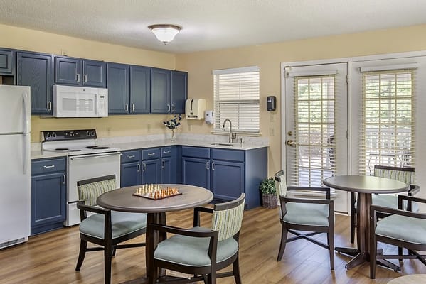 Bright common area with kitchenette and seating