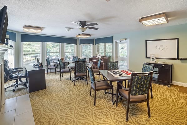 Bright common area with tables and chairs for activities