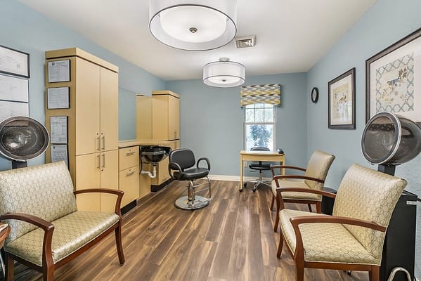 Interior of a salon area with styling chairs and storage