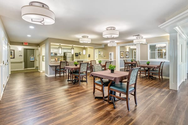 Dining area with tables and chairs in a bright interior