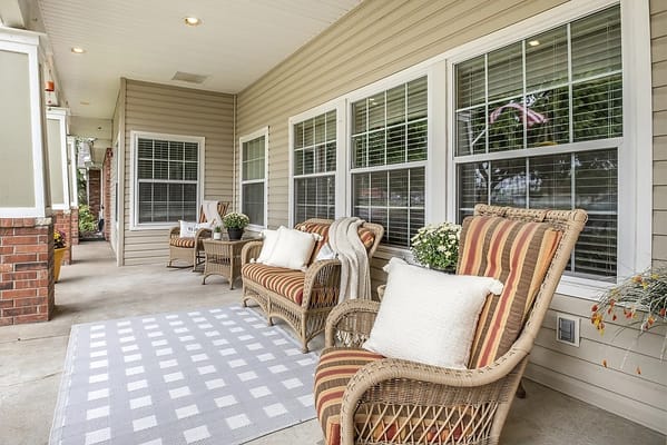 Outdoor seating area with wicker chairs and plants
