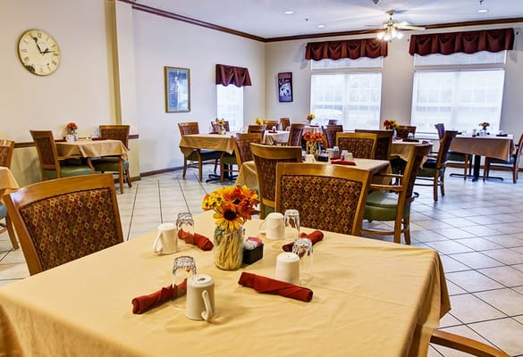 Bright dining room with tables set for residents