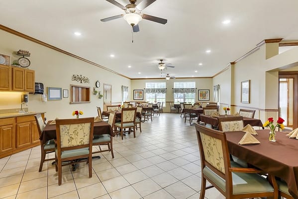 A dining area with tables set for residents