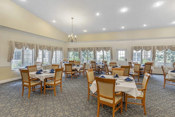 Bright dining room with tables set for meals