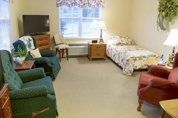 Cozy resident room with seating and floral decor