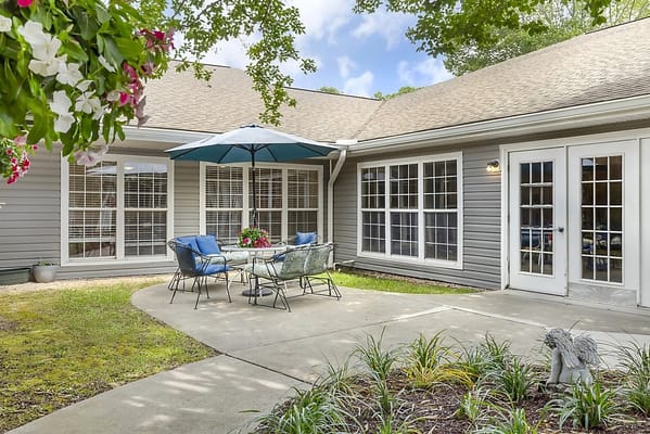 Outdoor seating area with umbrella and flowers