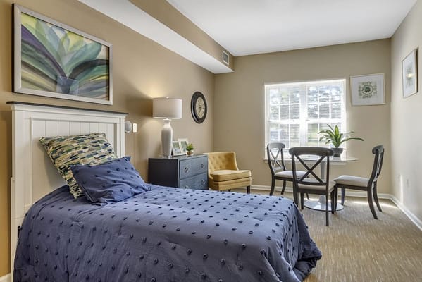 Cozy resident room with a bed and seating area