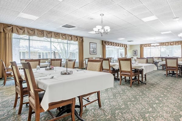 Dining room with tables and chairs set for a meal