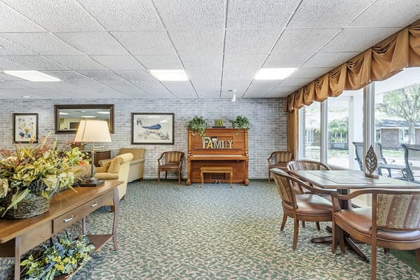 Bright common area with piano and seating