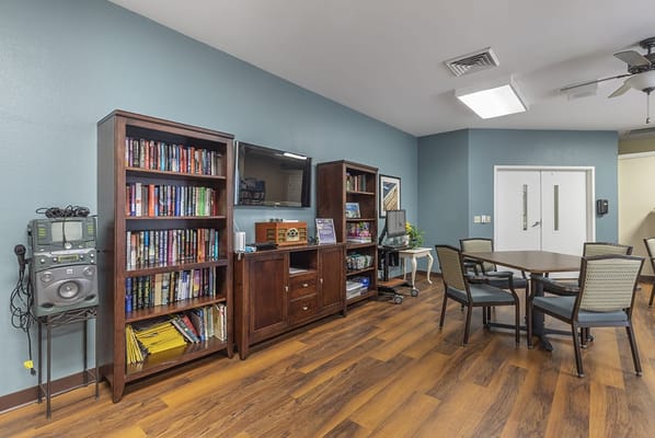 Common area with shelves, tables, and seating