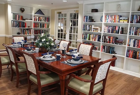 A dining setup in a cozy dining room with bookshelves