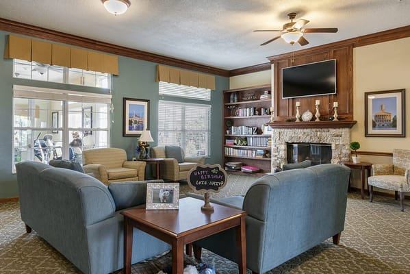 A cozy lounge area with seating and a fireplace