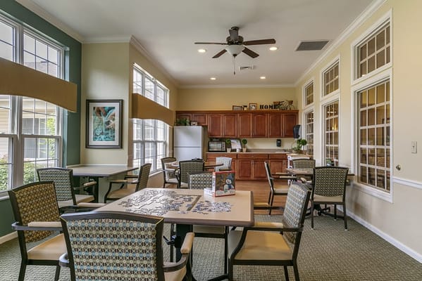 Common area with tables, puzzles, and a kitchen