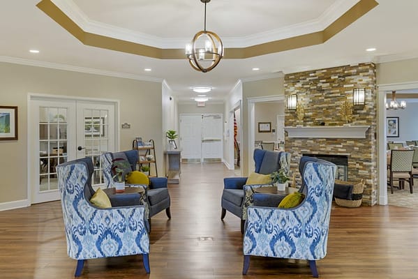 Common area with seating and fireplace in a nursing home