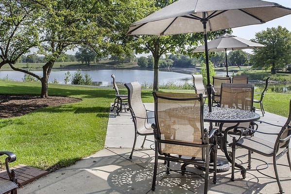 Outdoor seating area by a serene lake