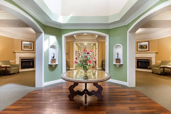 Interior view of a welcoming lobby with floral arrangement