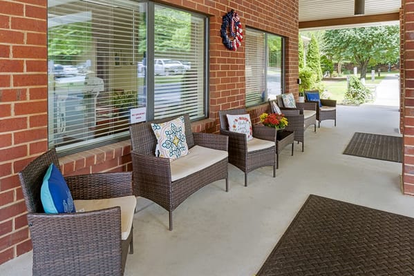 Seating area with wicker chairs and colorful cushions