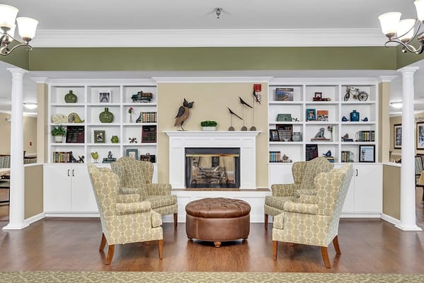 Cozy common area with armchairs and a fireplace