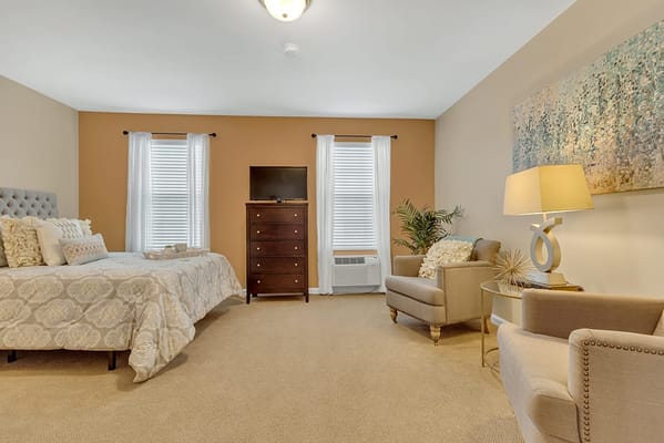 Cozy private resident room with a bed and seating area