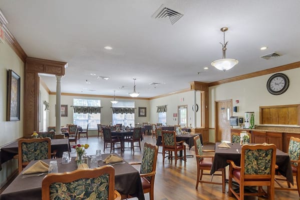 Dining area with tables and chairs set for meals