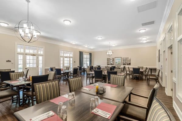Bright dining room with tables set for meals