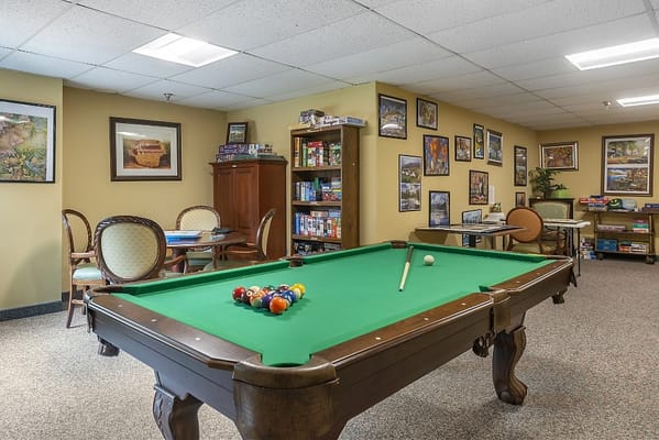 Interior game room with pool table and seating