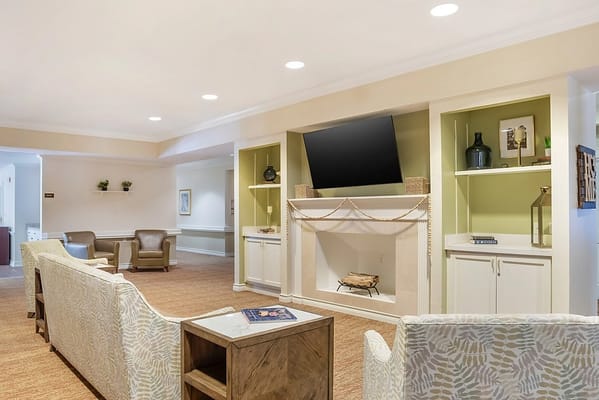 Bright common area with comfortable seating and a fireplace