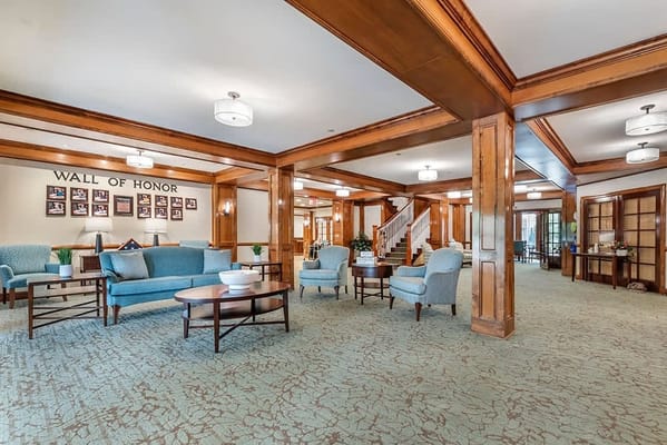 Bright common area with seating and honor wall