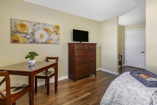 Cozy resident room with a bed and dining table