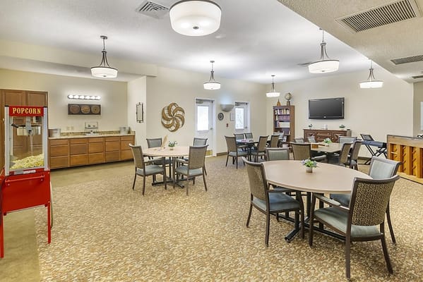 Bright common area with seating and popcorn machine