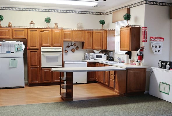 Interior kitchen space with wooden cabinets and appliances