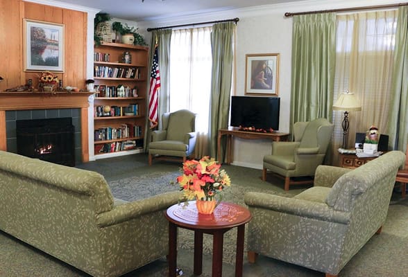 Cozy common area with chairs and bookshelf