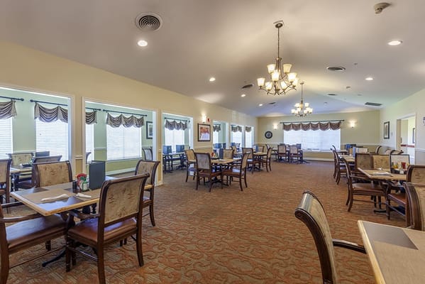 Dining area with tables and chairs in a well-lit room