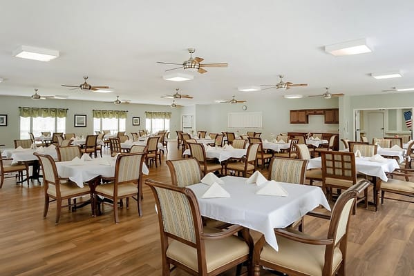Bright dining room with tables set for meals