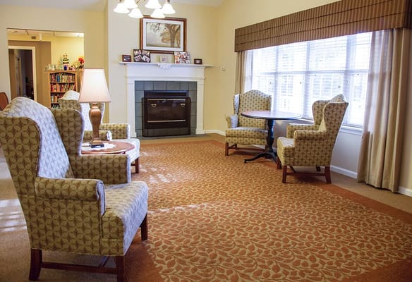 Bright common area with seating and a fireplace