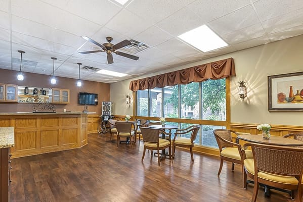 Bright common area with seating and large windows