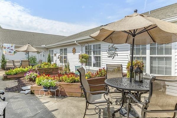 Sunny outdoor patio with flowers and seating