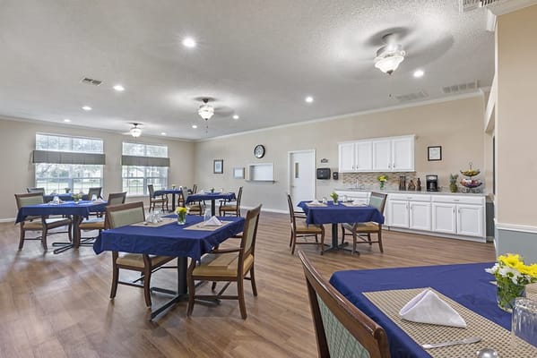Bright dining room with tables set for meals