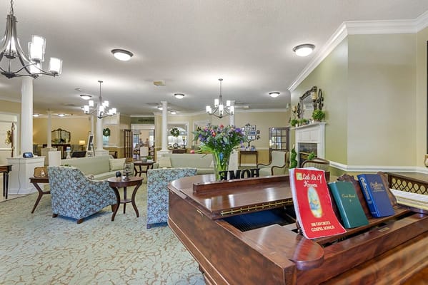 Interior view of a welcoming common area with piano