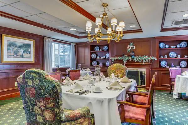 Well-set dining room with floral chairs and elegant decor