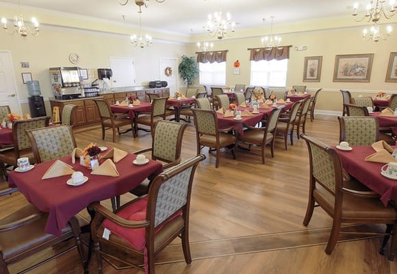 Dining room setup with tables and decorative centerpieces