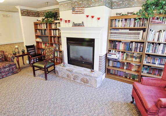 Cozy common area with bookshelves and fireplace
