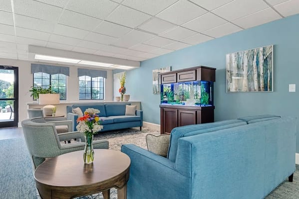 Bright common area with seating and aquarium