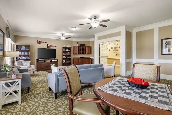 Bright common area with seating and entertainment options