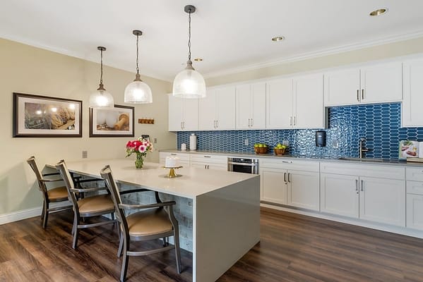 Modern kitchen in a senior living facility with seating