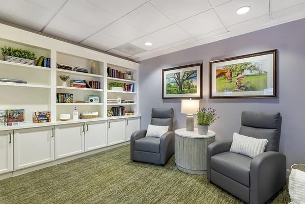 A cozy interior space with comfortable seating and bookshelves