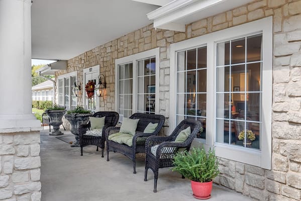 Outdoor seating area with wicker chairs and decorative plants