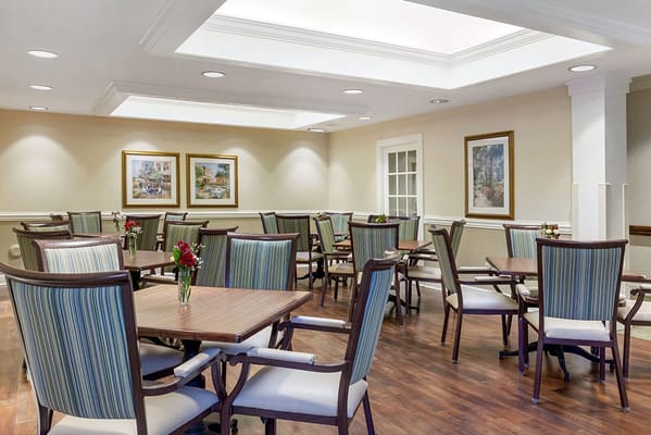 Dining area with tables and chairs in a well-lit room
