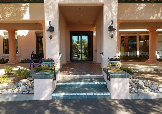 Entrance area of a senior living facility with decorative pots