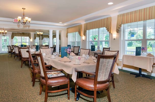 Bright, inviting dining room with tables set for meals